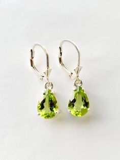 Peridot dangle earrings in Silver or Gold. Natural Peridot 10mm x 7mm genuine stones set in Sterling Silver handmade settings.  The Peridot are about 3 carats total and a very nice green color.  The settings for these Peridot drop earrings are handmade by me and the lovely Peridot hang down from lever backs which keep them safely in your ears.  Peridot is the birthstone for August.  These lovely Peridot earrings make a great gift for all ages.  I can also sell just one piece, please convo me if Elegant Green Jewelry With Lever Back Ear Wires, Nickel-free Round Peridot Earrings, Elegant Pierced Peridot Jewelry, Elegant Oval Peridot Earrings, Classic Green Earrings With Ear Wire, Formal Peridot Drop Earrings, Classic Green Drop Earrings, Elegant Lime Green Jewelry For May Birthstone, Nickel-free Peridot Elegant Jewelry