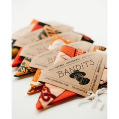 several different types of ties are laid out on a white surface with the tag labeled bandit's