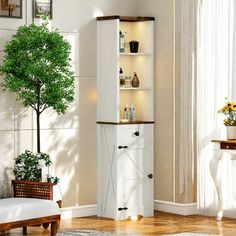 a living room with white furniture and a tree in the corner on top of it