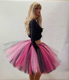 Make a statement and capture everyone's attention with this eye-catching Black, Shocking Pink, and Fuchsia Tutu Skirt. Designed to impress, this vibrant skirt is meticulously crafted by tying strips of tulle onto a highly stretchy elastic band, ensuring a comfortable and secure fit for all-day wear. Whether you're planning a family photoshoot, celebrating a birthday party, enjoying holidays, or simply seeking to add a touch of whimsy to your day, this tutu skirt is the perfect choice. Its vibrant colors of black, fuchsia, and shocking pink create a visually stunning contrast that will make you stand out from the crowd. For sizes 14 and above, this tutu skirt is 20 inches long, allowing for graceful movement and showcasing its vibrant colors. For smaller child sizes, the skirt is tailored t Black Tutu, Shocking Pink, Pink Tutu, Poses For Photos, Tutu Skirt, Family Photoshoot, Pink And Black, Elastic Band, Knee Length