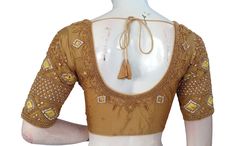 Adorn your bridal ensemble with this breathtaking handcrafted Indian silk saree blouse, meticulously crafted in the USA and embellished with the radiant artistry of gold-colored Aari embroidery. Made from the finest silk fabric, this blouse drapes gracefully, its rich texture complementing the intricate Aari work that adorns it. * This Is A Fully Stitched Saree Blouse, Ready To Wear * Made of Semi silk, Lined With Cotton * Opens From Front With Hook and eye-fitting MEASUREMENTS: Sleeve: 10.5 inc Yellow Blouse Piece With Intricate Embroidery In Traditional Drape, Yellow Blouse Piece With Intricate Embroidery, Transitional Gold Choli With Cutdana, Yellow Blouse For Transitional Wedding Season, Yellow Semi-stitched Blouse Piece With Intricate Embroidery, Semi-stitched Yellow Blouse Piece With Intricate Embroidery, Gold Embroidered Fabric For Designer Wear, Gold Silk Saree With Intricate Embroidery, Gold Saree With Intricate Embroidery For Transitional Season