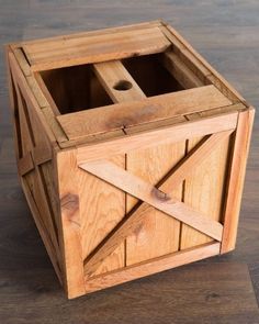 an unfinished wooden box on the floor