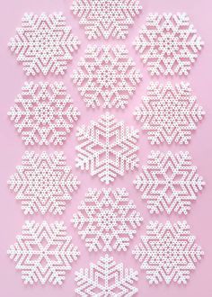 white snowflakes are arranged on a pink background with space for the wording