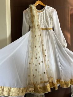 -Beautifull white kathak Anarkali with zari gota detailing - can be made in any colors and sizes - design can be changed as per requirement - the dress includes * full flared kathak Anarkali with cotton lining inside *gold gota patti work dupatta * fine quality leggings pants * gold and white matching belt to hold dupatta over the waist  - we offer bulk discounts for group dance costumes - get in touch +91 7737288355 We customise any kind of Indian attire as per your choice and measurement. Just Kathak Costume Anarkali, Kathak Dress Design, White Traditional Drape Dress For Festivals, Traditional Drape White Dress For Festivals, White Dresses For Festivals With Traditional Drape, Elegant White Maxi Salwar Kameez, White Dress With Pallu For Eid, White Anarkali Floor-length Dress, White Saree Dress For Navratri