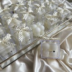 the table is decorated with white and black polka dot bow decorations, which are on display in clear acrylic boxes