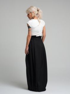 Make a bold statement with our high-waist skirt, the epitome of tailored elegance. This skirt is fashioned from premium polyester, delivering a smooth finish with a substantial feel that gracefully flows with every step. The design is accentuated by a tasteful belt that cinches the waist, while the elasticated back ensures a snug and comfortable fit. Its voluminous silhouette and sleek lines make it a versatile piece for both office wear and evening affairs. FEATURES:Includes a chic belt, elasticated back for comfort, and a high-waist cut 100% Handmade. SIZE & FIT: Fit: A relaxed fit with room to moveModel is wearing size Small or S/M View our SIZE CHART before ordering MATERIALS & CARE: Content: Polyester Care: Dry cleaning only SHIPPING: Made to order, processing time is 15 working days Chic Culottes With Loosely Fitted Hips, High-waist Fitted Maxi Skirt For Formal Occasions, Formal High-waist Fitted Maxi Skirt, Fitted Black Maxi Skirt For Work, Fitted High Waist Maxi Skirt For Formal Occasions, Formal High Waist Fitted Maxi Skirt, Chic Spring Skirt With Wide Waistband, Fitted Belted Pleated Skirt For Work, High Waist Solid Color Evening Skirt