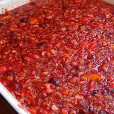 a white dish filled with lots of red food