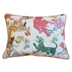 a white pillow with colorful animal designs on the front and back of it's sides