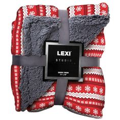 a red and white blanket with a black label on the bottom that says exit studio