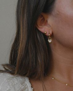 a close up of a person wearing some kind of earrings