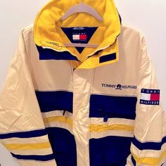 This Jacket Is A Thing Of Beauty. The Outer Is Made Up Of Mostly Rugged Nylon Panels In Cream, Dark Blue, And Yellow That Repel Water And Offer Great Durability, While The Interior Is All Plush Yellow Fleece. It’s Suitable For Use As A Winter Coat, But Breathable Enough To Use In Warmer Weather. Condition Is 10/10, Considering It’s Age, Though There Are Minor Spots And Scuffs Here And There. Nothing Large Or Noticeable. No Structural Issues With Any Zippers Or Velcro Or Anything. There’s A Nice Thick Hood Packed Away In The Collar As Well. Size Says Large On The Tag, But It Would Fit A Mens Xl Better. It’s A Bit On The Bigger Side As Far As Coats Go. Sporty Cream Windbreaker For Winter, White Track Jacket For Winter Sports, White Fleece-lined Sports Outerwear, White Sports Outerwear With Fleece Lining, Sporty Cream Outerwear For Outdoor, Cream Windbreaker For Winter Streetwear, White Sporty Windbreaker For Cold Weather, White Windbreaker With Fleece Lining And Long Sleeves, White Windbreaker With Pockets For Cold Weather