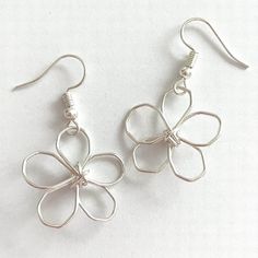 Mini daisy flower statement earrings. Wire handworked, in silver plated, gold plated, or rose gold plated wire that has been wrangled into an abstract, primitive daisy motif. These drop earrings are ultra modern and bring an effortless charm into any wardrobe.  One of a kind. A mini version of my best selling large daisy flower earrings.  Each pair is made to order and slight variations may occur. Earrings are approximately 1" in length, very lightweight, and on French earwires. Makes a beautiful gift for mom, sis, or a best friend. And you can request gift wrap with a personal gift message to make it all the more perfect! Due to the delicate nature of these earrings they should not be allowed to catch on anything, be pulled on, or worn during any activity where they may come in hard conta Delicate Silver Flower Earrings Nickel-free, Delicate Silver Flower Earrings Nickel Free, Delicate Silver Nickel-free Flower Earrings, Silver Delicate Nickel-free Flower Earrings, Silver Flower Metal Earrings For Spring, Silver Metal Flower Earrings For Spring, Dainty Metal Jewelry In Flower Shape, Spring Silver Metal Flower Earrings, Flower Shaped Metal Jewelry For Spring