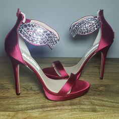 Gorgeous Ankle-Cuff Rhinestone Embellishment On Crimson Satin. Back Zip Entry. As Much As I Love These, I Tore My Acl In A 5k And Can No Longer Wear Heels. Now Someone Else Can Love Them! Brand New, Never Worn. Comes With Original Box. Maintained In A Pet-Free And Smoke-Free Home. -Heel Height: 5 Inches -Platform: 1/2 Inch -Satin Upper -Composition Leather Sole Holiday Embellished Ankle Strap Heels, Glamorous Red Sandals For Wedding, Elegant Red Sandals With Rhinestones, Holiday Party Embellished Sandals, Red Rhinestone Sandals For Formal Occasions, Formal Red Sandals With Rhinestones, Glamorous Red Sandals For Gala, Glamorous Red Sandals For Party, Glamorous Red Embellished Sandals