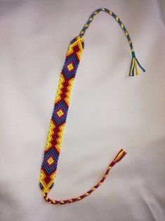 a multicolored beaded lanyard with a tassel hanging from it's end