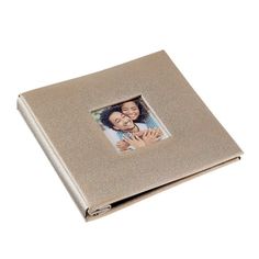 a silver photo album with an image of two people holding each other in the middle