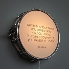 a drum with a quote written on the front and back of it that says, rhythm is something you either have or don't have but when you have it all over