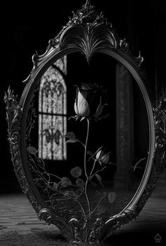 a mirror with a rose in the middle of it and a stained glass window behind it