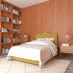 a bed sitting in a bedroom next to a book shelf