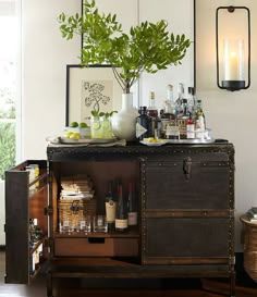 an old trunk is filled with liquor bottles and wine glasses as well as other items