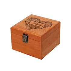 a wooden box with an engraved heart on the front and sides, sitting on a white background