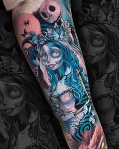 a woman with blue hair and skull tattoos on her arm