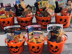 halloween buckets filled with candy and snacks