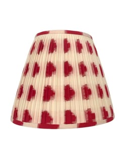 a red and white lampshade with hearts on the bottom, against a white background