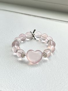 ❤️Add a touch of elegance and tranquility to your jewelry collection with this beautiful Rose Quartz bracelet. Crafted from smooth, round beads, this bracelet captures the gentle pink hue of Rose Quartz, known as the stone of universal love. ▫️Material: Genuine Rose Quartz Round Beads; Heart-shaped Rose Quartz, DIY accessories  ▫️Bead Size: 12mm ▫️Rose quartz heart size: 15mm*10mm ▫️Bracelet length: fits wrist length 15cm (6in)+  ✅Care Instructions: ✔️Keep away from harsh chemicals and prolonged exposure to water. ✔️Clean with a soft cloth to maintain its natural shine. 🔺Please note:  ☑️All photos are taken in the natural daylight with no filter applied. ☑️Each bead in the bracelet is unique. The presence of dark spots, white lines and yellow hues add to the natural beauty of your bracele Rose Quartz Round Beads Jewelry For Valentine's Day, Elegant Heart-shaped Beaded Friendship Bracelets, Valentine's Day Rose Quartz Beaded Jewelry, Elegant Pink Beaded Bracelets With Heart Beads, Elegant Beaded Heart-shaped Stretch Bracelet, Elegant Pink Heart Beaded Bracelets, Elegant Pink Heart-shaped Beaded Bracelets, Rose Quartz Round Beads Bracelet For Valentine's Day, Elegant Adjustable Stretch Bracelet With Heart Beads