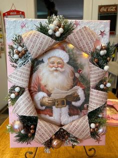 a christmas card with a santa clause holding a piece of paper in it's hand