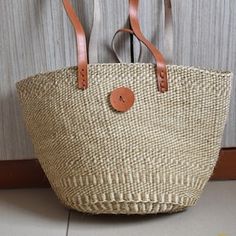 a straw bag hanging on the wall