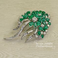 Stunning burst of vivid green emeralds and sparkly white diamonds covering all the surfaces of this beautiful platinum vintage brooch! Total Weight: 29.15 grams Size: 2.5 inch tall, 1.5 inch wide Precious Metal: Platinum Precious stones: -Emeralds: QTY: 31, 2.7mmx4.7mm to 4.2mmx6.3mm size, 7.5 carats -Diamonds: 29 rounds, 20 baguettes, 6 carats Vintage Green Diamond Brooches, Green Diamond Wedding Brooches, Luxury Green Brooch For Anniversary, Luxury Green Brooches For Anniversary, Green Fine Jewelry Brooches For Wedding, Fine Jewelry Green Brooch For Anniversary, Fine Jewelry Green Brooches For Anniversary, Green Fine Jewelry Brooch For Anniversary, Green Gemstone Brooch For Anniversary