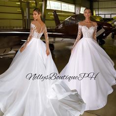 two women in wedding dresses standing next to an airplane