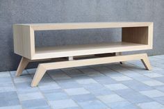 a wooden shelf sitting on top of a tiled floor