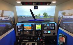 the cockpit of an airplane with two monitors on each side and three other screens above it