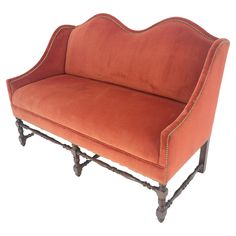 an orange couch sitting on top of a wooden frame