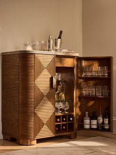 a wooden cabinet with wine glasses and liquor bottles