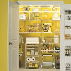 an open pantry with yellow walls and shelves