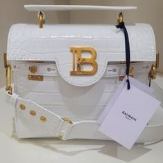 Brand New Balmain Buzz 23 Bag In White Croc Effect Leather. Luxury Shopping Flap Bag Shaped Like A Satchel, Luxury Flap Bag With Removable Pouch For Shopping, Luxury Shopping Tote Flap Bag, Luxury Shopping Flap Bag With Detachable Strap, Luxury Top Handle Flap Bag For Shopping, Luxury Flap Bag With Gold-tone Hardware For Shopping, Designer Flap Bag With Gold-tone Hardware For Shopping, White Luxury Flap Bag With Gold-tone Hardware, Luxury White Flap Bag With Top Handle