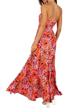 Flirty cutouts at the bodice add to the summery vibes of this strapless maxi dress covered in a vibrant floral print. Hidden side-zip closure Sweetheart neck Strapless Partially lined 100% rayon Hand wash, dry flat Imported Strapless Dresses For Summer Beach Parties, Floral Print Maxi Strapless Dress For Garden Party, Bandeau Maxi Dress For Beach, Strapless Dresses For Spring Summer Parties, Floor-length Maxi Dress For Spring And Summer Parties, Fitted Strapless Floral Maxi Dress, Casual Strapless Dresses For Summer Parties, Pink Bandeau Maxi Dress For Summer, Summer Vacation Bandeau Maxi Dress