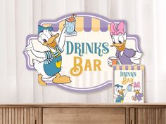 a sign that says drinks bar with donald and daisy characters on it next to a book