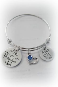 "Hand-Stamped Personalized Aunt Bangle Bracelet Bracelet features two custom-stamped discs along with an open heart charm and a Swarovski birthstone drop. Fashioned on an expandable stainless steel bangle bracelet. The fully adjustable bangle measures 60mm and fits wrists 7-8\" Comes in either an organza pouch or a giftbox depending upon which option you select. ♦ ♦ ♦ ♦ ♦ ♦ ♦ ♦ ♦ ♦ ♦ ♦ ♦ ♦ ♦ ♦ ♦ ♦ Only one side can be stamped as it shows through on reverse side. ♦ ♦ ♦ ♦ ♦ ♦ ♦ ♦ ♦ ♦ ♦ ♦ ♦ ♦ ♦ ♦ ♦ Motorcycle Keychain, Harley Davidson Gifts, Best Auntie Ever, You Are Precious, Organza Pouch, Stainless Steel Bangles, Adjustable Bangle, Open Heart, Birthstone Jewelry