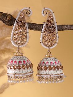 Experience the allure of timeless elegance with our exquisite pastel green Kundan polki jhumkas in ambi design . Done in meenakari work these hand painted  earrings exude a captivating charm, combining the lustre of gold with the intricate beauty of Kundan craftsmanship. Step into a world of grace and radiance with these stunning earrings. Embrace the enchantment they exude and let them become a reflection of your own elegance and sophistication. White Cutdana Jhumkas For Wedding, Wedding White Cutdana Jhumkas, White Tilla Bridal Earrings For Eid, White Bridal Earrings With Tilla For Eid, White Jhumkas For Wedding And Eid, Festive White Cutdana Bridal Earrings, White Jhumkas For Wedding And Navratri, Traditional White Jhumkas With Gota Work, Meenakari Danglers For Wedding And Navratri