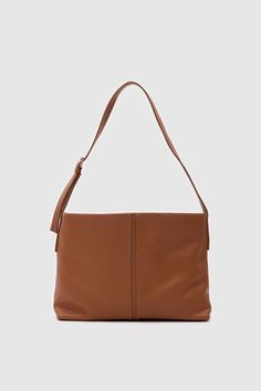 Elevate your style with this sophisticated faux leather shoulder bag. Designed for both elegance and functionality, this bag boasts a minimalist silhouette that complements any outfit. Material: Made from high-quality, smooth leather that provides a luxurious feel and long-lasting durability. Design: The bag features a clean, seamless design with subtle stitching along the edges, highlighting its refined craftsmanship. Its classic black color ensures versatility, making it an ideal accessory for Modern Hobo Bag With Smooth Grain For Everyday Use, Versatile Soft Leather Baguette Bag For Everyday, Minimalist Everyday Bag With Detachable Strap, Everyday Versatile Soft Leather Baguette Bag, Minimalist Leather Bags With Detachable Strap, Minimalist Leather Shoulder Bag With Detachable Strap, Modern Shoulder Bag With Double Handle And Smooth Grain, Solid Color Leather Crossbody Baguette Bag, Modern Everyday Baguette Bag With Detachable Strap