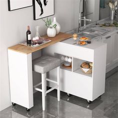 a kitchen with a sink, counter and stools