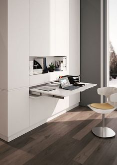 an office with white furniture and wood flooring in the room, including a computer desk