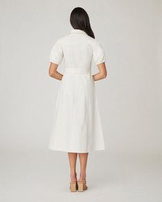 Beautiful ivory denim midi shirtdress. This style features short lantern sleeves, a shirt collar with front button placket, a fitted bodice with pockets flaps above the bust, a fitted waist with tie belt, and a full A-line skirt with side seam pockets. Unlined. Button front. 100% Cotton. Dry clean only. Color: Ivory