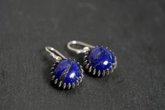 Lapis Lazuli stone is beautiful, textured deep blue with hits of gold color in it, stunning! Such a pretty, modern silver bezel. Earrings are 10mm 13mm with the sterling bezel. Sterling Silver Ear Hooks. -PRESENTATION & GIFTING- All of our jewelry comes beautifully wrapped in a hand stamped kraft jewelry box with a bow; ready for gifting! Just leave a note and I will include a personalized message for your gift recipient. Every piece of jewelry comes with a free cleaning cloth! -ABOUT US- We've Elegant Lapis Lazuli Earrings With Natural Stones, Handmade Round Lapis Lazuli Earrings, Everyday Blue Earrings With Natural Stones, Blue Lapis Lazuli Earrings For Formal Occasions, Handmade Sapphire Round Earrings, Blue Minimalist Pierced Jewelry, Unique Blue Earrings For Everyday, Formal Blue Lapis Lazuli Earrings, Unique Blue Everyday Earrings