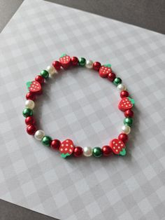 1 x beaded bracelet  * made with acrylic pearl beads and polymer clay strawberry beads  * elasticated; one size fits all Beaded Strawberry Bracelet, Polymer Clay Strawberry, Beaded Strawberry, Strawberry Bracelet, Clay Strawberry, Strawberry Beads, Strawberry Jewelry, Fruit Bracelet, Fruit Strawberry