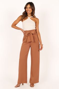 DETAILS    Step into timeless sophistication with our stylish Wide Leg Pant! The high-waisted design and gathered pleated waistband give you a flattering silhouette that's perfect for any occasion.   wide leg style pant  high waisted  gathered pleated waist band  front functional zip with hook and eye clasp  belt loops with detachable waist tie  functional pockets  lined   material - 100% polyester    SIZING    model is 5' 6" and wears a Size 2  model stats: bust - 31", waist - 23", hips - 34" Satin Dresses Long, High Waisted Wide Leg Jeans, Satin Dresses Long Sleeve, Black Tie Wedding Guests, White Dress Shoes, Style Pant, Essential Dress, Crop Top Tees, Dresses By Length