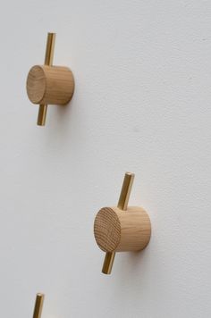 two wooden knobs are attached to the wall